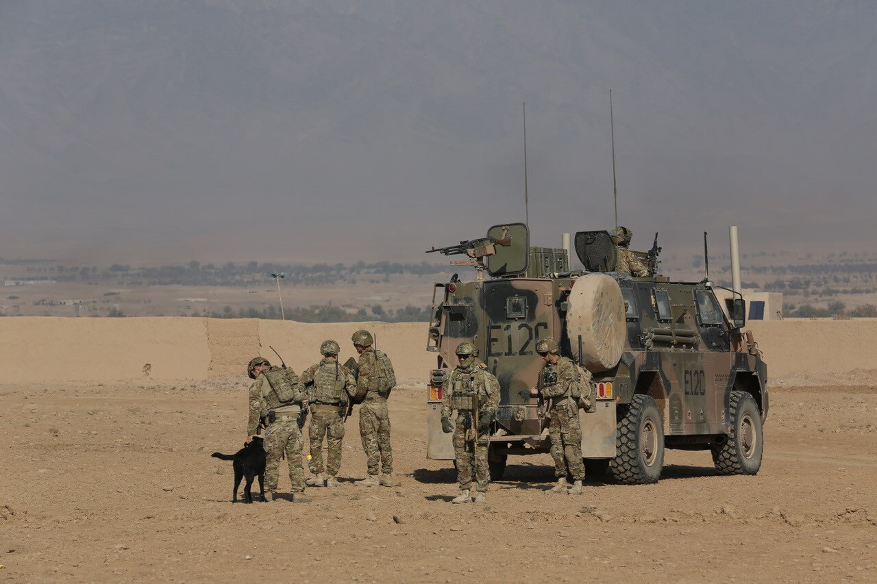 6 Section, 2 Troop and SPR Rob Muraru with EDD Shuba from 23 Support Squadron during a Ground Defence Area Patrol in Tarin Kowt, Afghanistan in 2013.